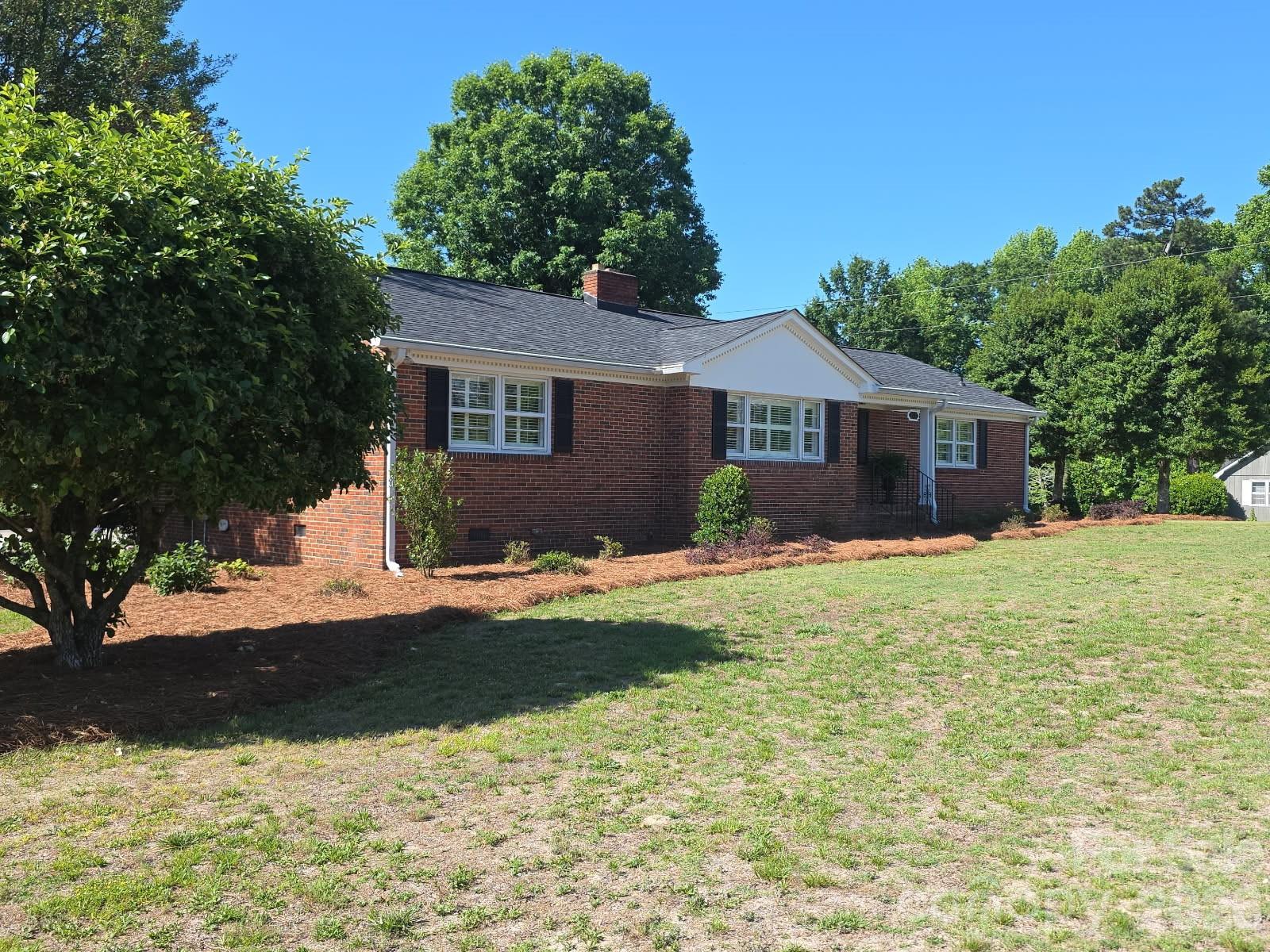 313 Pigg Street Pageland, SC 29728 - Photo 3 of 48 a front view of a house with a yard and garage