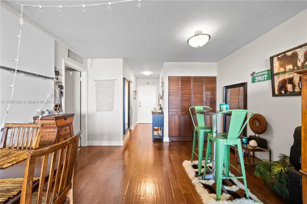 a view of a livingroom with furniture gym wooden floor and windows
