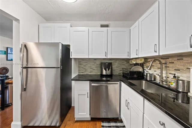 a kitchen with stainless steel appliances granite countertop a refrigerator sink and cabinets