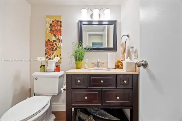 a bathroom with a sink a mirror and a toilet