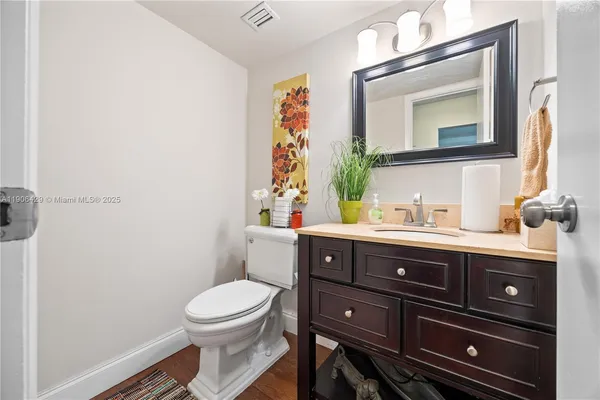 a bathroom with a toilet a sink and mirror