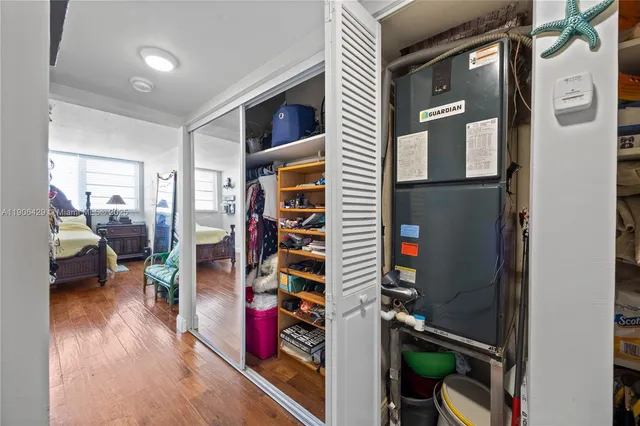 a view of a hallway with wooden floor and windows