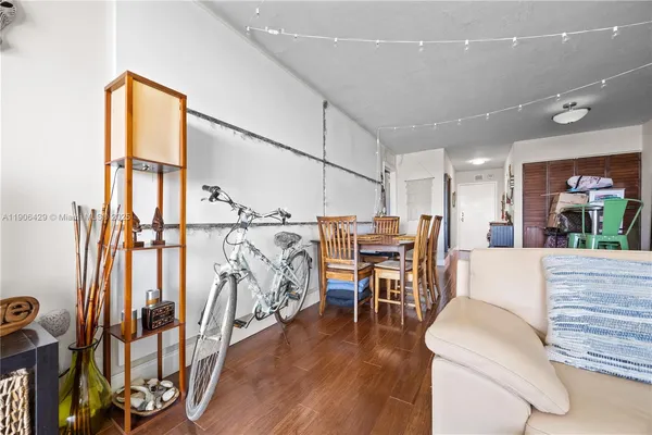 a living room with furniture a fireplace and wooden floor
