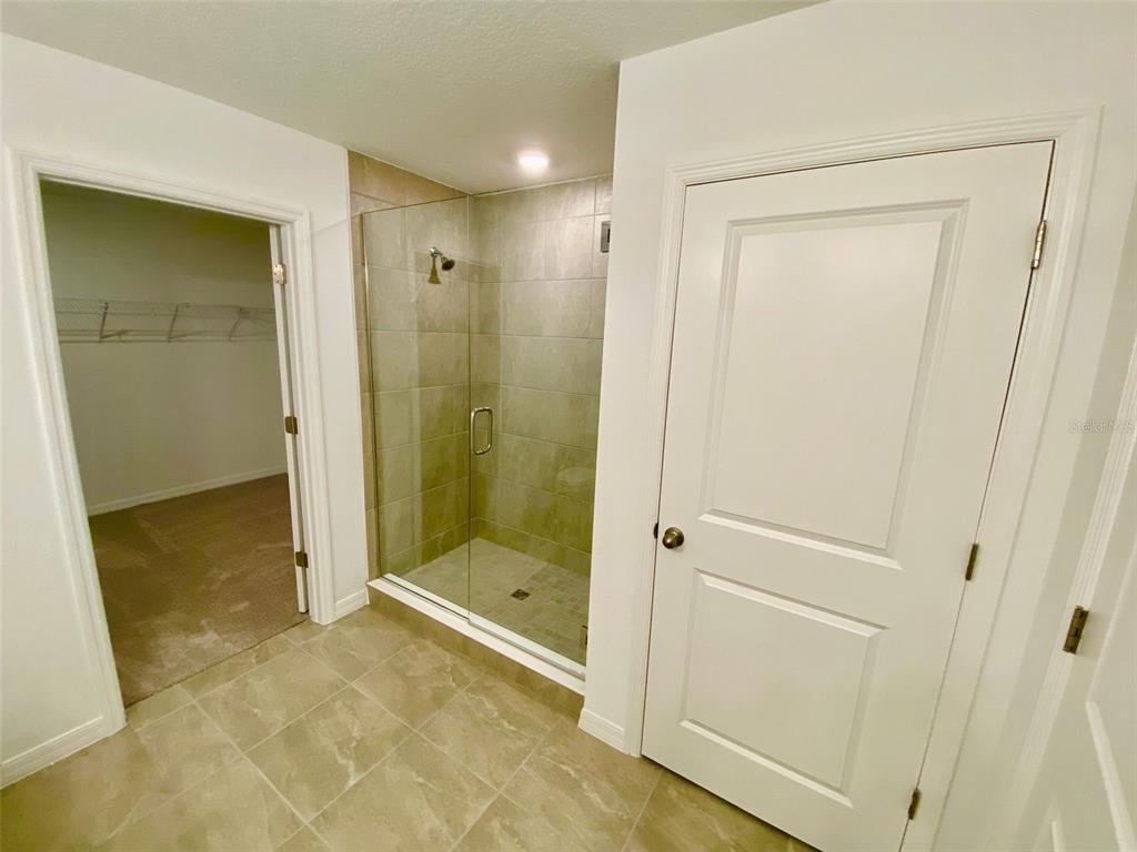 2190 Derwent Drive Davenport, FL 33896 - Photo 14 of 30 a view of a bathroom with a glass shower door