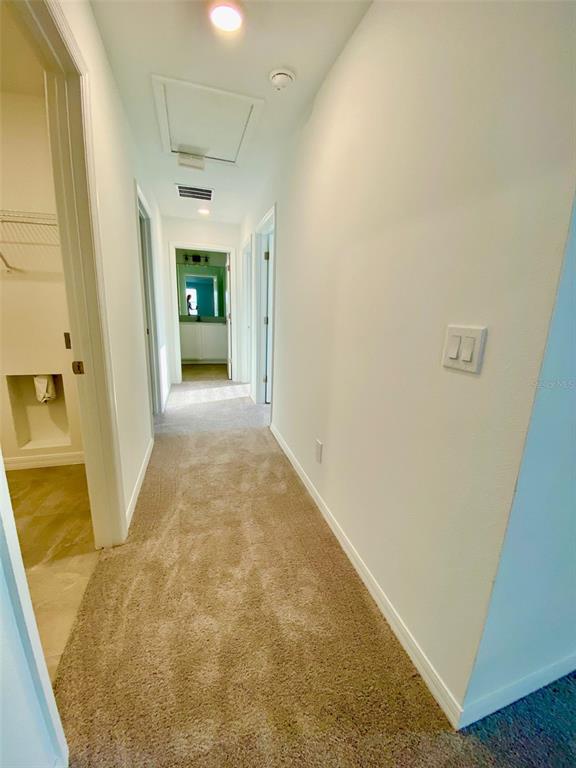 2190 Derwent Drive Davenport, FL 33896 - Photo 18 of 30 view of a hallway with wooden floor and a bathroom