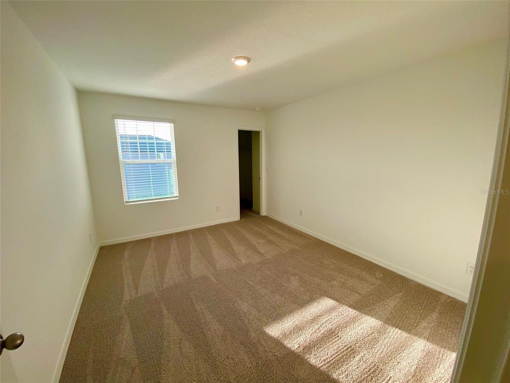 2190 Derwent Drive Davenport, FL 33896 - Photo 22 of 30 an empty room with windows