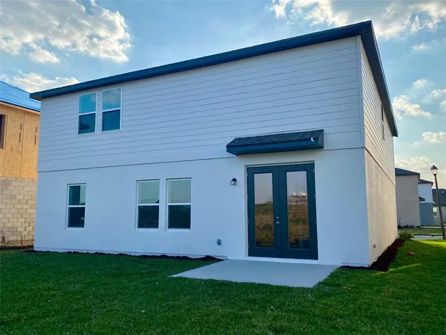 a large kitchen with stainless steel appliances kitchen island granite countertop a stove a sink a counter top space and cabinets