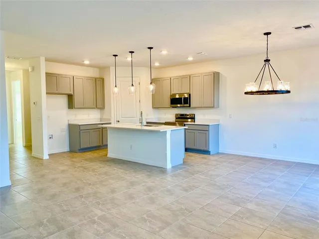 a large kitchen with cabinets and stainless steel appliances