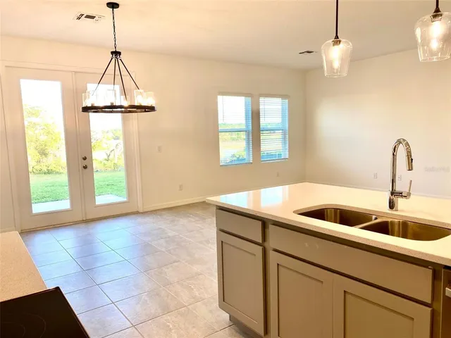 a kitchen with a sink a counter top space and a window