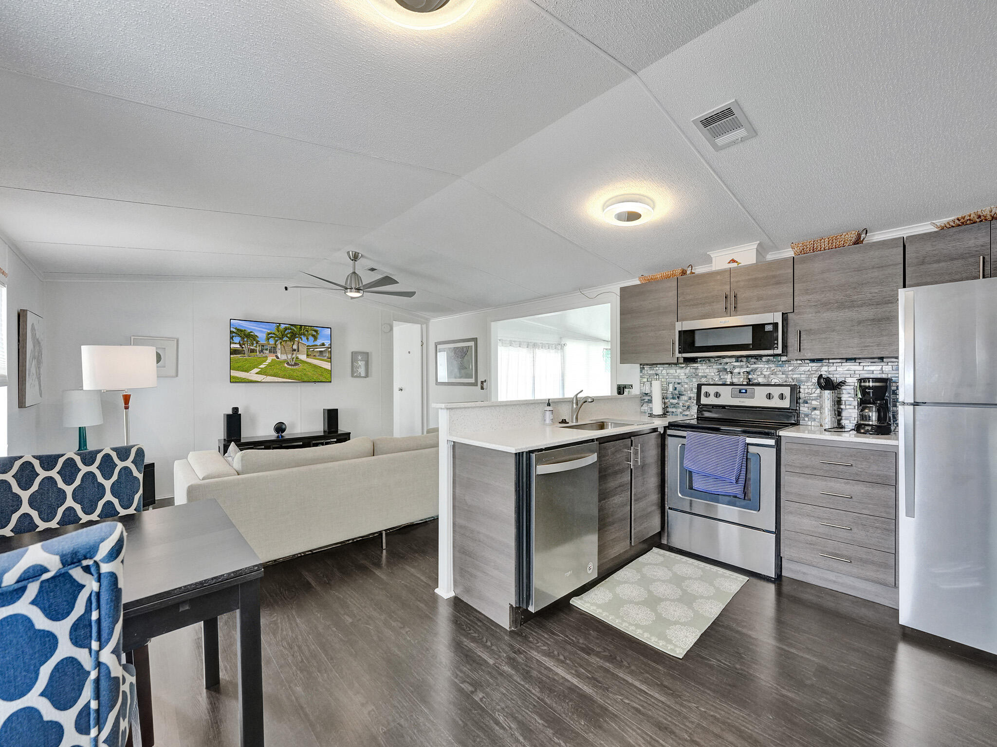 14609 Sunset Drive Delray Beach, FL 33445 - Photo 12 of 50 a kitchen with stainless steel appliances kitchen island granite countertop a stove refrigerator and sink