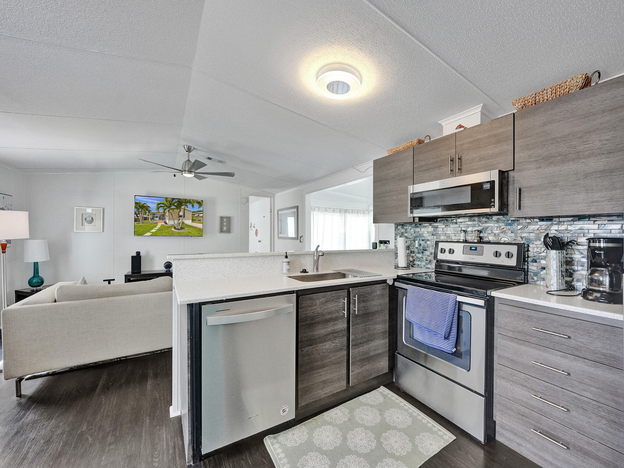 14609 Sunset Drive Delray Beach, FL 33445 - Photo 14 of 50 a kitchen with appliances cabinets and a sink