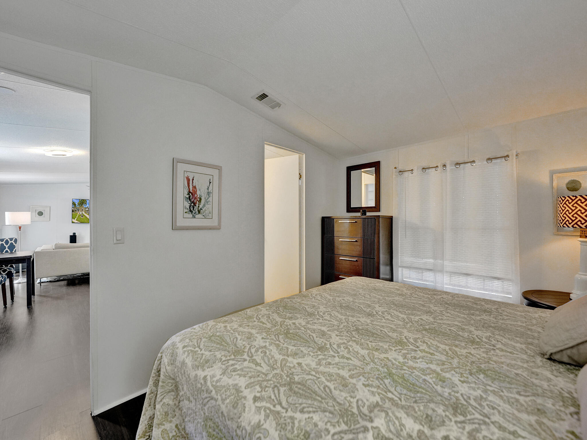 14609 Sunset Drive Delray Beach, FL 33445 - Photo 18 of 50 a bedroom with a bed and a table