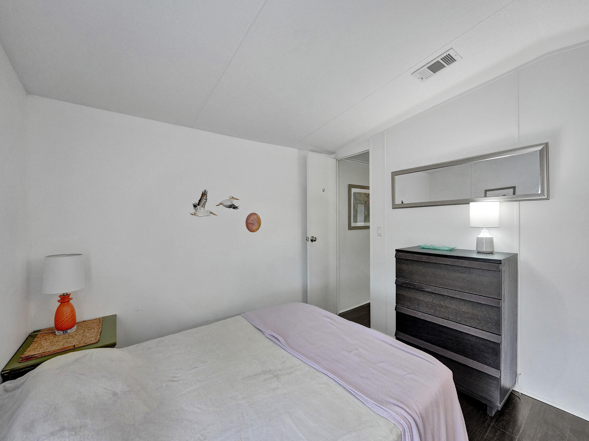 14609 Sunset Drive Delray Beach, FL 33445 - Photo 29 of 50 a bedroom with a bed and a walk in closet