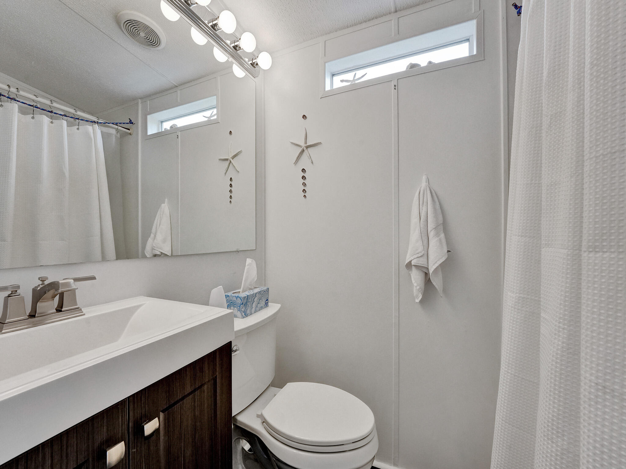 14609 Sunset Drive Delray Beach, FL 33445 - Photo 30 of 50 a bathroom with a sink a toilet and shower