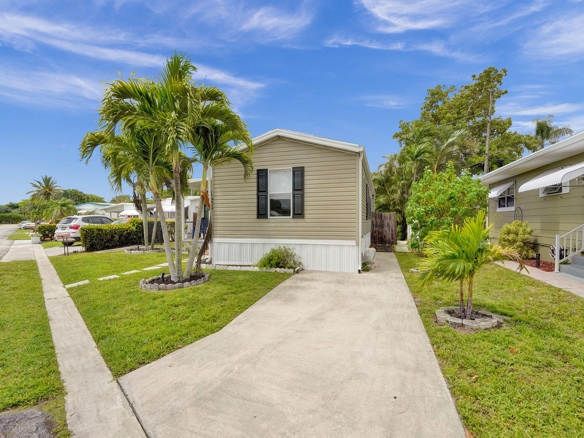 14609 Sunset Drive Delray Beach, FL 33445 - Photo 3 of 50 a front view of a house with a yard