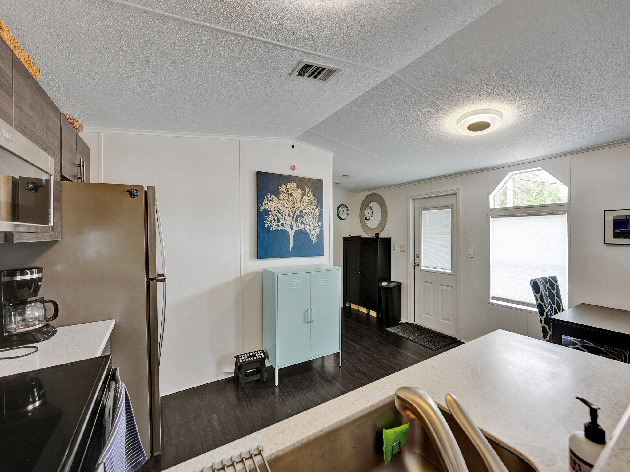 14609 Sunset Drive Delray Beach, FL 33445 - Photo 34 of 50 a kitchen with sink refrigerator and window
