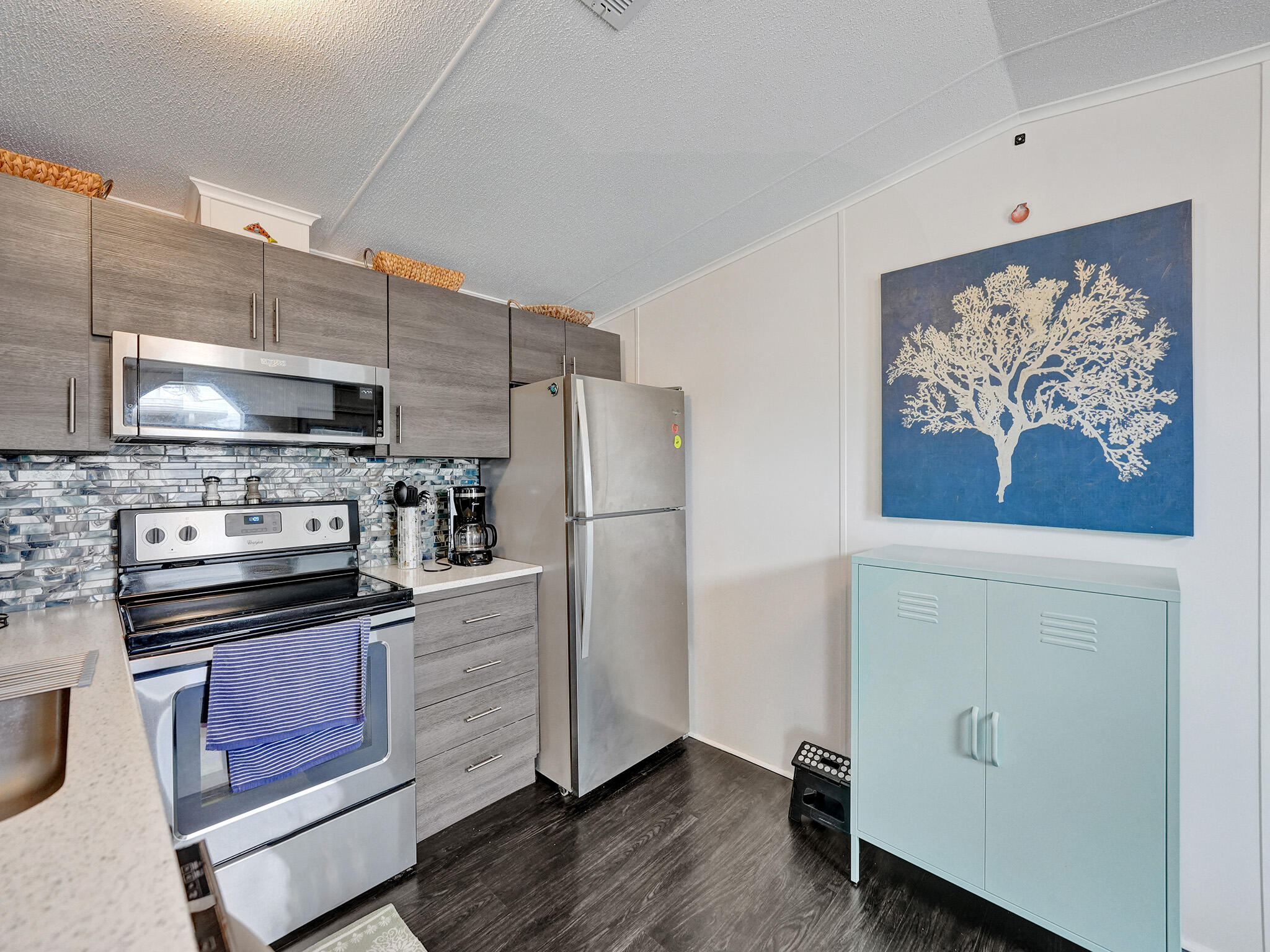 14609 Sunset Drive Delray Beach, FL 33445 - Photo 35 of 50 a kitchen with stainless steel appliances cabinets and wooden floor