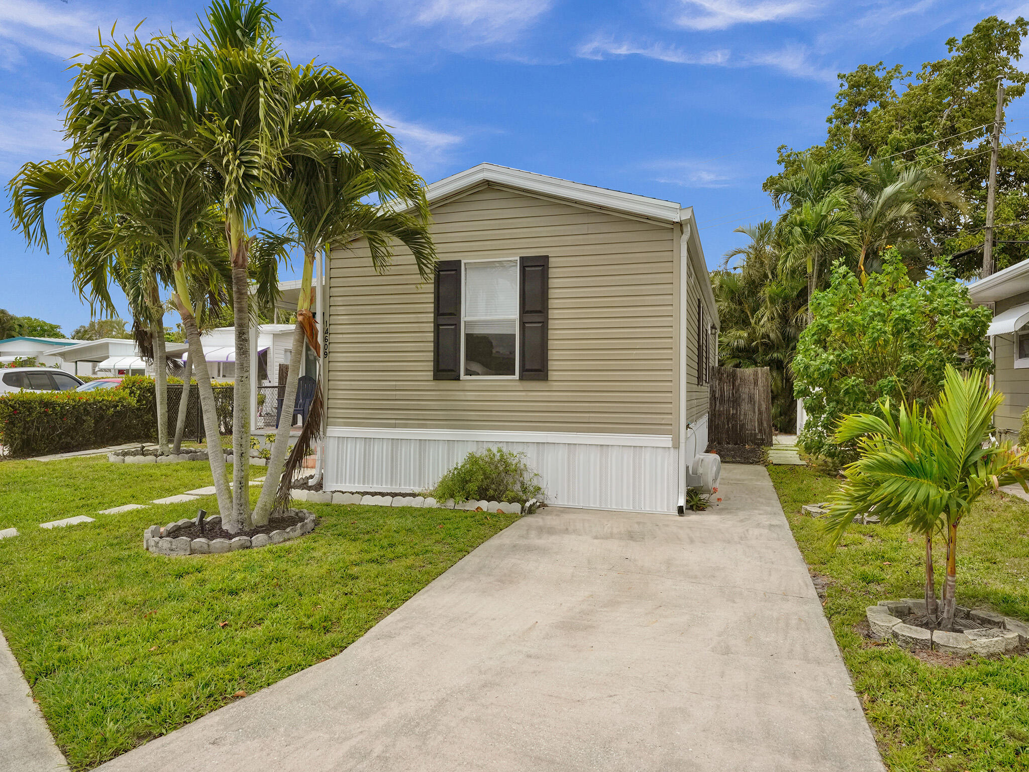 14609 Sunset Drive Delray Beach, FL 33445 - Photo 4 of 50 a front view of a house with garden