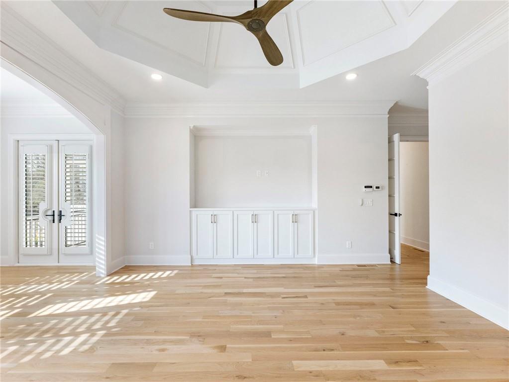 5651 Old Wilkie Road Gainesville, GA 30506 - Photo 30 of 78 a view of a livingroom with wooden floor and a ceiling fan