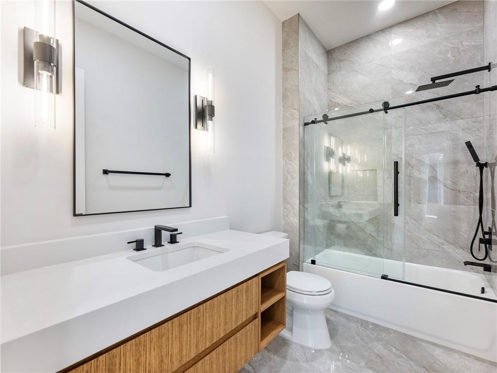 5651 Old Wilkie Road Gainesville, GA 30506 - Photo 42 of 78 a bathroom with a sink a toilet and shower