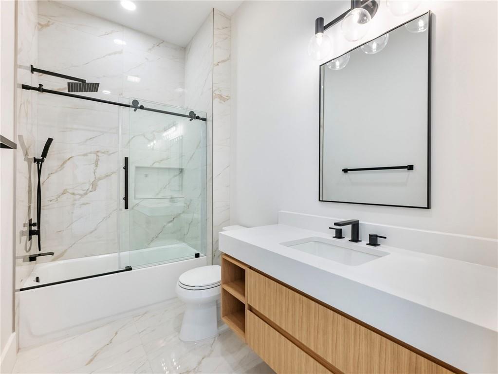 5651 Old Wilkie Road Gainesville, GA 30506 - Photo 44 of 78 a bathroom with a sink a toilet and shower