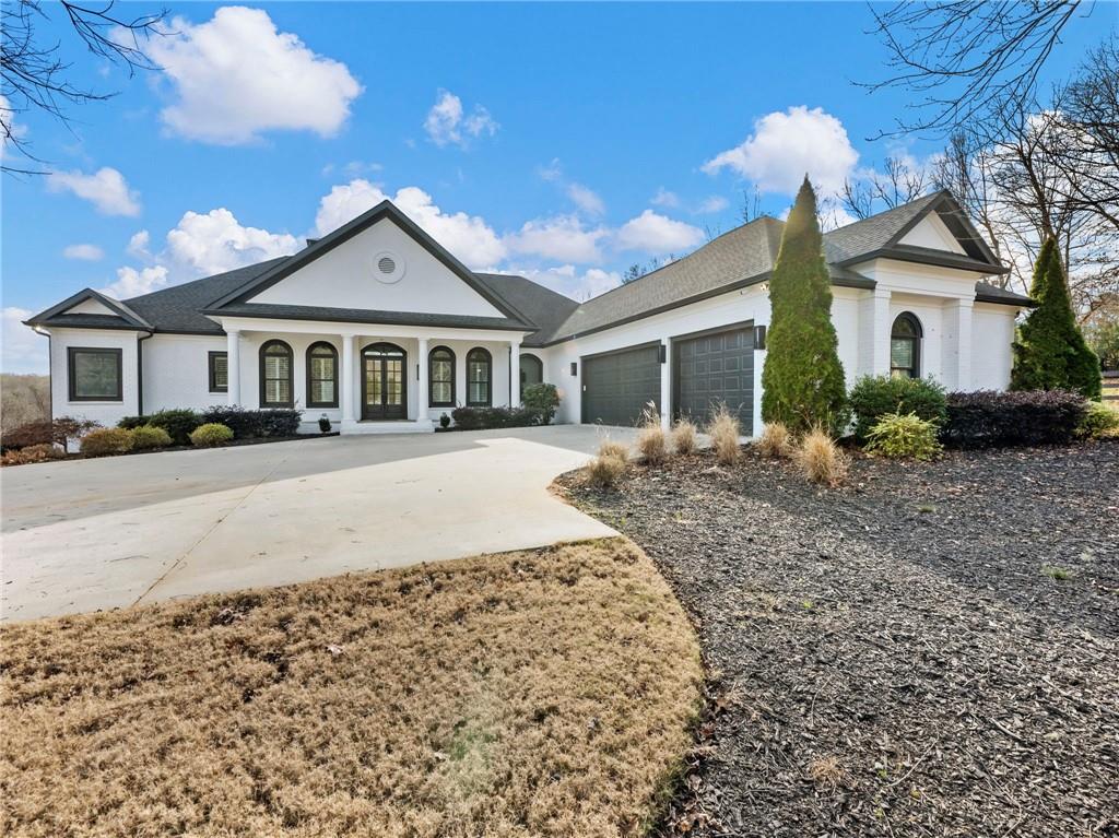 5651 Old Wilkie Road Gainesville, GA 30506 - Photo 72 of 78 a front view of a house with a yard and garage