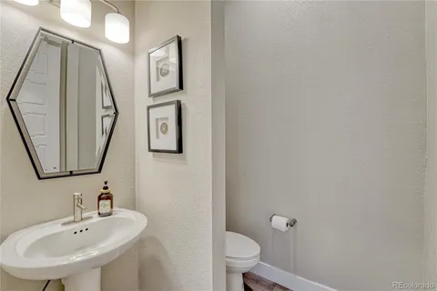 a bathroom with a toilet a sink and mirror