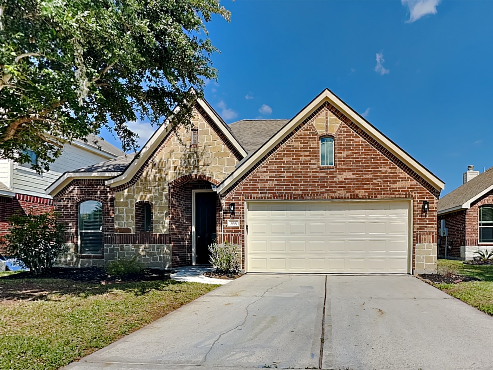 3007 Lockeridge Village Drive Spring, TX 77386 - Photo 1 of 18 a front view of a house with a garden and plants