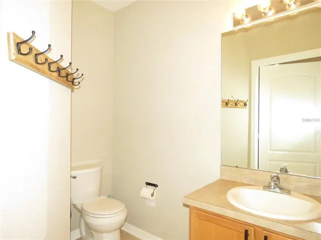 a bathroom with a sink toilet and a mirror