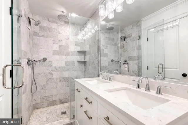 a bathroom with a double vanity sink mirror and shower