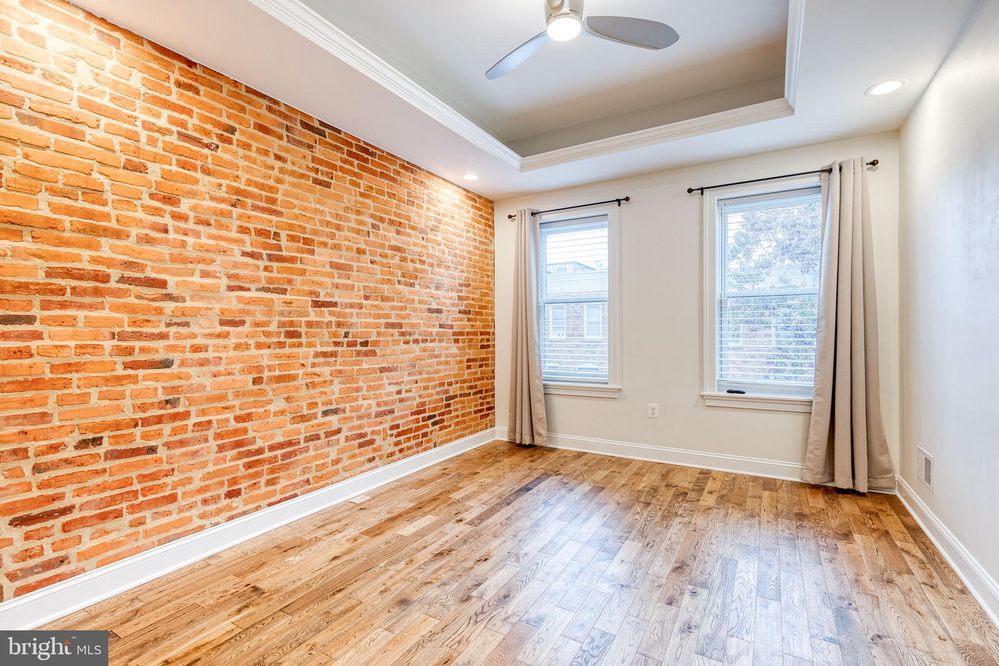 635 South Curley Street Baltimore, MD 21224 - Photo 17 of 20 a view of an empty room with a window and wooden floor