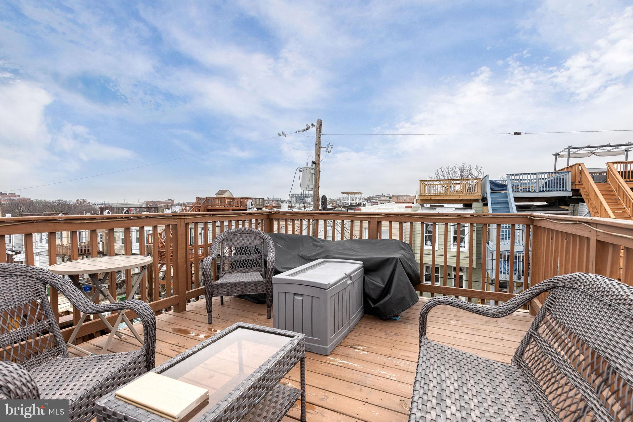 635 South Curley Street Baltimore, MD 21224 - Photo 18 of 20 a view of a balcony with wooden chairs