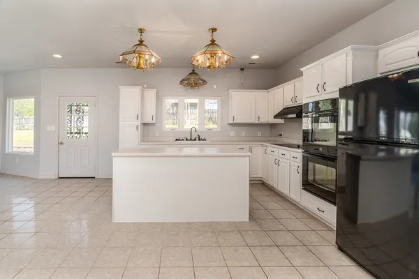 a kitchen with a sink cabinets and window