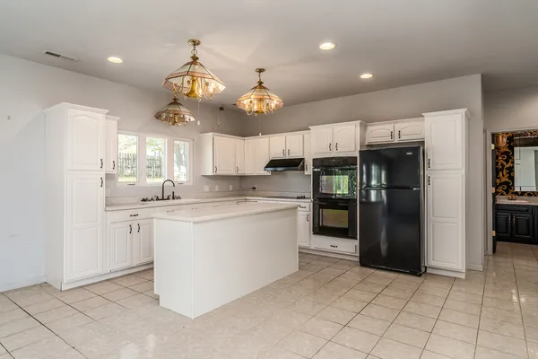 a kitchen with a cabinets and chandelier