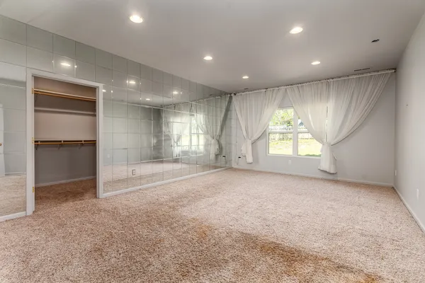 a view of an empty room with windows