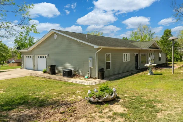 a view of a house with swimming pool and a yard