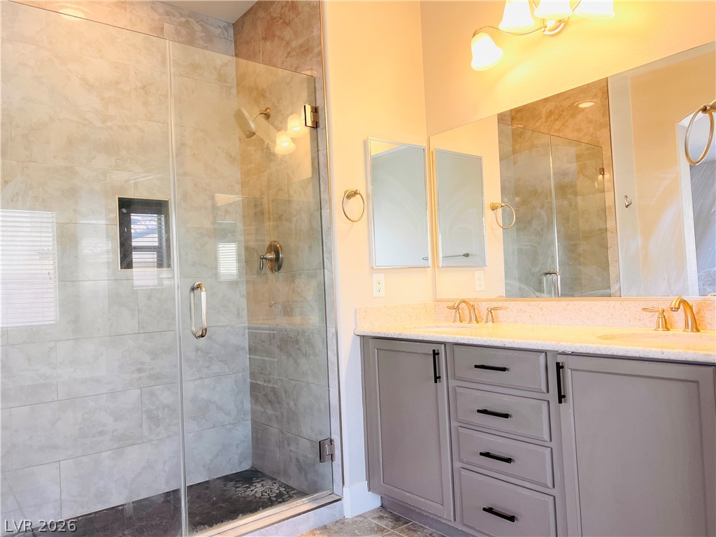 161 Dunblane Street Henderson, NV 89012 - Photo 51 of 56 A well-appointed bathroom features a spacious glass-enclosed shower and a dual vanity with ample counter space.