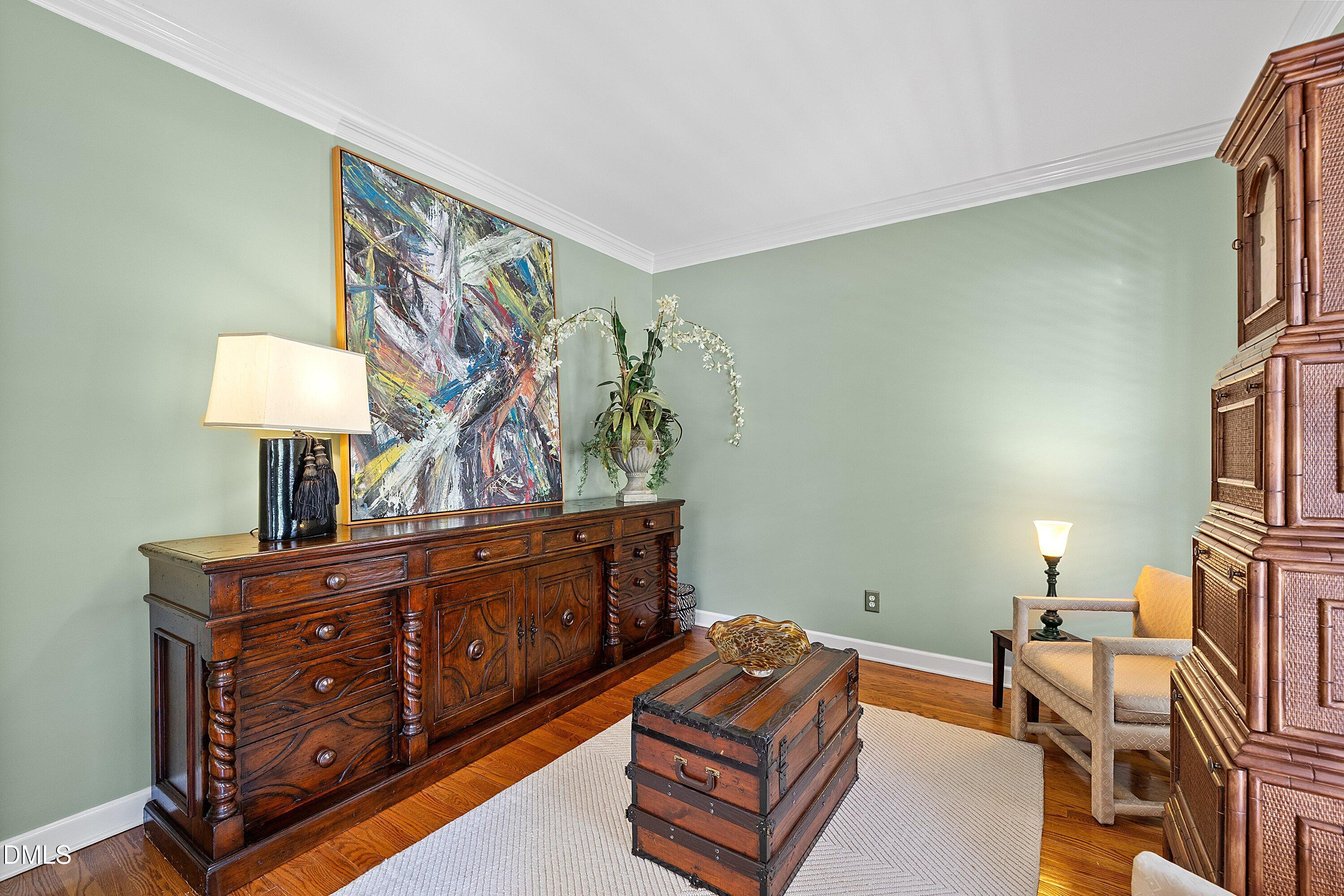 3914 Sterling Ridge Lane Durham, NC 27707 - Photo 12 of 66 Hardwood flooring throughout, crown molding detail, and light-toned wall finishes