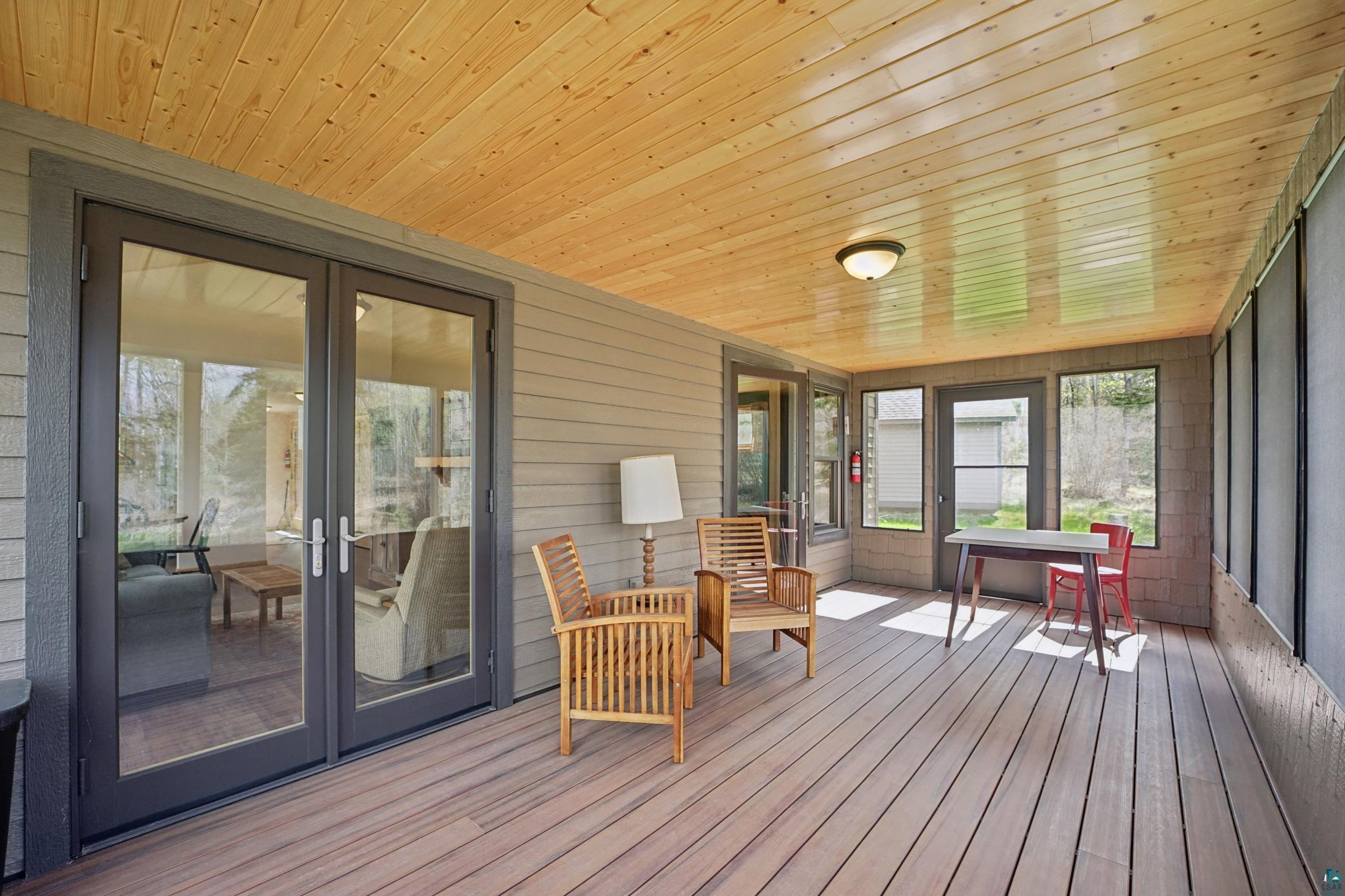 89095 West Romans Point Road Herbster, WI 54844 - Photo 10 of 30 Screened porch featuring a natural wood-finish plank ceiling, composite decking, and dual-pane glass French doors
