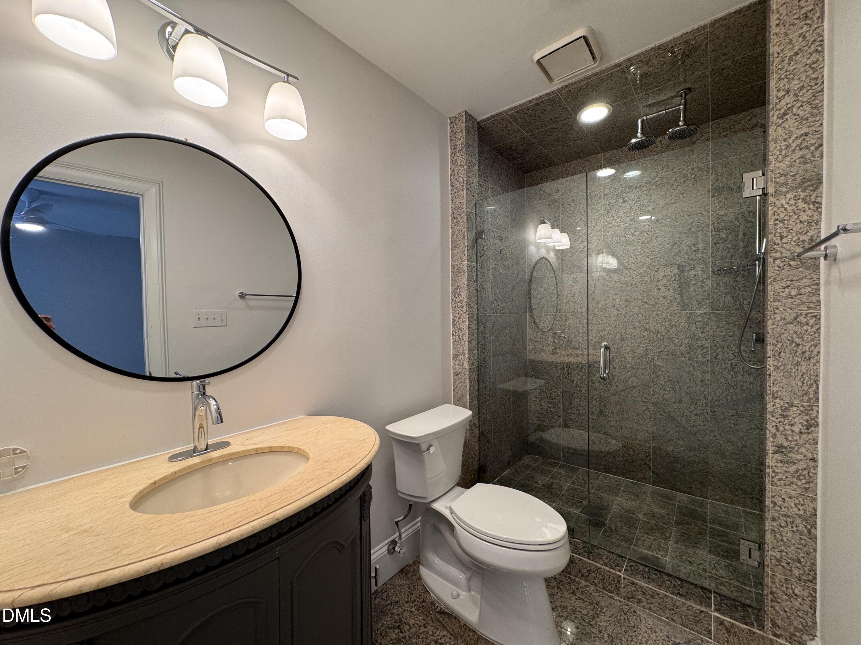 2204 Stafford Avenue, Unit 202 Raleigh, NC 27607 - Photo 14 of 15 a bathroom with a toilet a sink and mirror