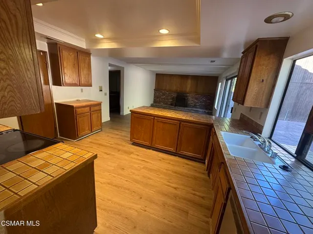 a kitchen with a refrigerator and a stove top oven