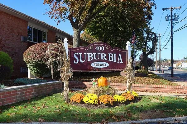 a view of a sign board with a yard