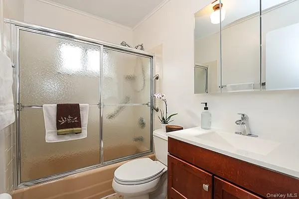 a bathroom with a sink a mirror a toilet and shower