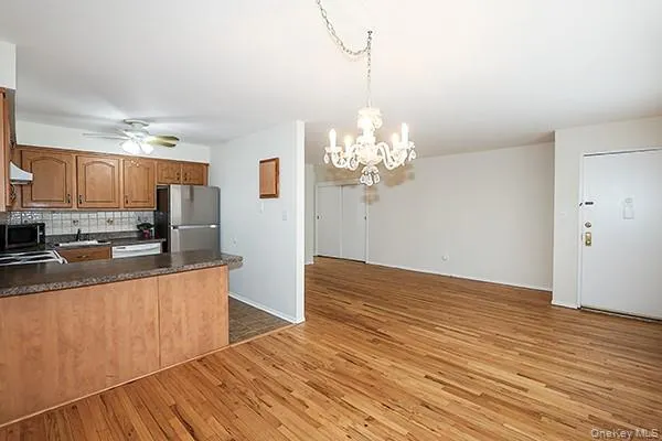 a view of a kitchen with wooden floor