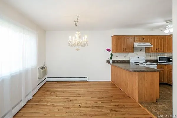 a view of kitchen with stainless steel appliances granite countertop a stove a sink and a refrigerator