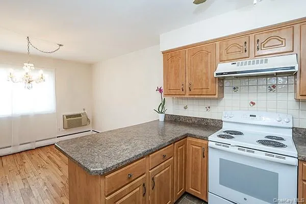 a kitchen with granite countertop a sink stove and cabinets