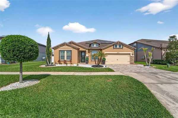 a front view of a house with a yard and garage