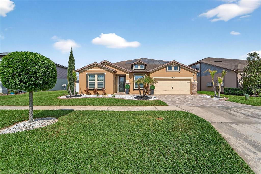 a front view of a house with a yard and garage