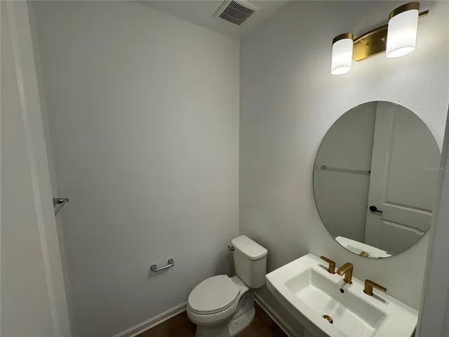 a view of a room with wooden floor and staircase