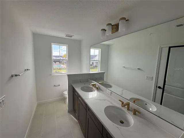 a kitchen with sink stove and refrigerator